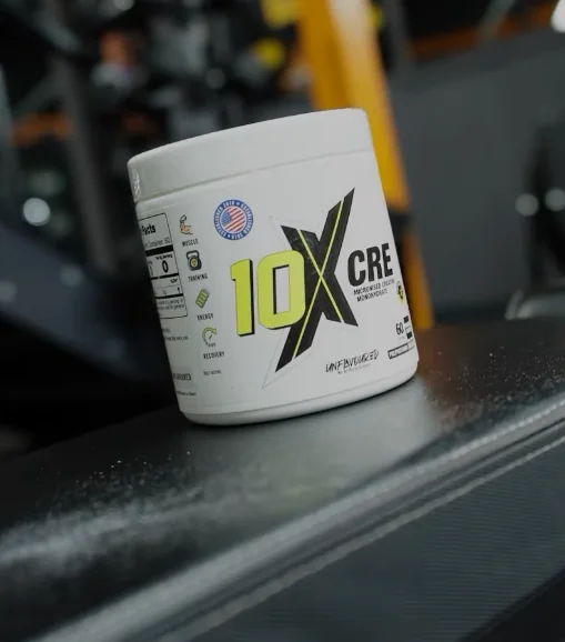 Tub of 10X Athletic creatine monohydrate on a gym bench